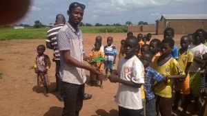 Director of Head Ghana distributing educational materials to school children to welcome them to school at my first day at school programme at Jawani in the Northern part of Ghana